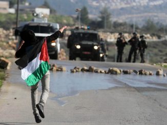 Palestinian youth throws stones at Israeli troops