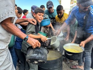 Palestinians at a food distribution point in Jabaliya, northern Gaza, on 19 October